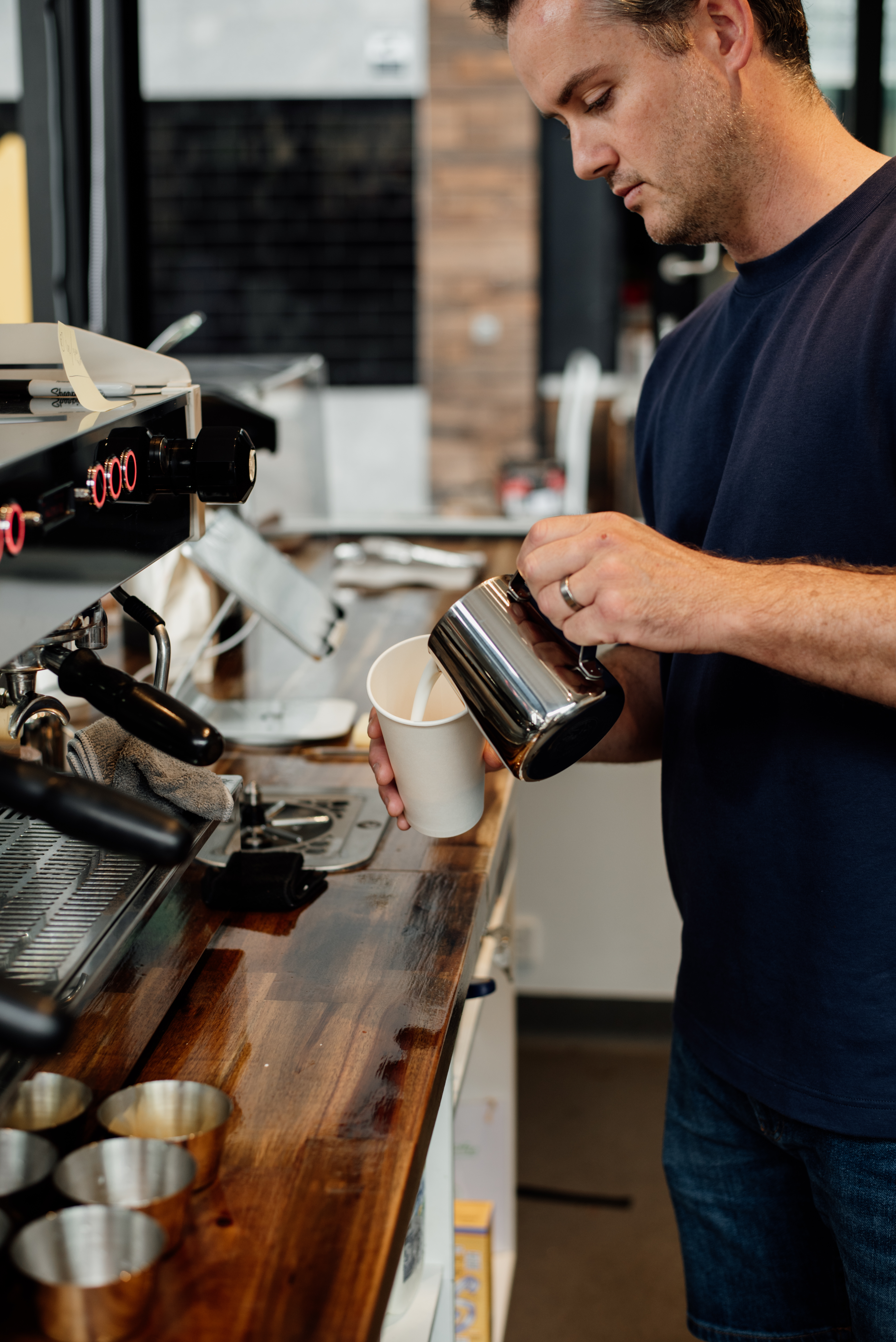 Boxboy Coffee barista pouring latte art